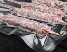 7-mutton-minced-meat-on-skewers-in-vacuum-pack-set-on-black-wooden-table-background.jpg