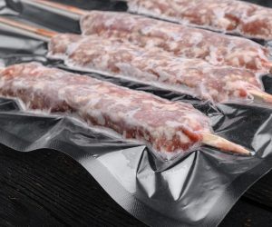 7-mutton-minced-meat-on-skewers-in-vacuum-pack-set-on-black-wooden-table-background.jpg